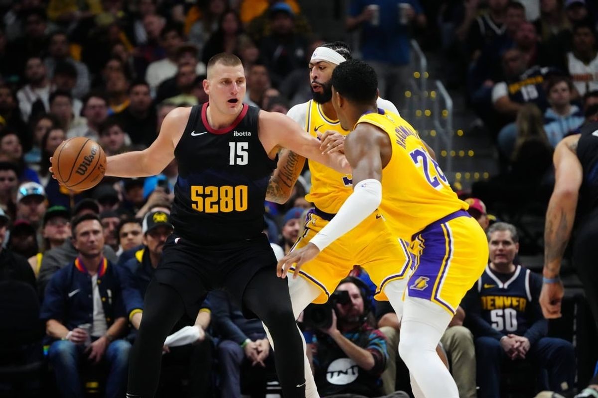Apr 22, 2024; Denver, Colorado, USA; Los Angeles Lakers forward Anthony Davis (3) and Los Angeles Lakers forward Rui Hachimura (28) defend Denver Nuggets center Nikola Jokic (15) in the first half during game two during the 2024 NBA playoffs at Ball Arena.
