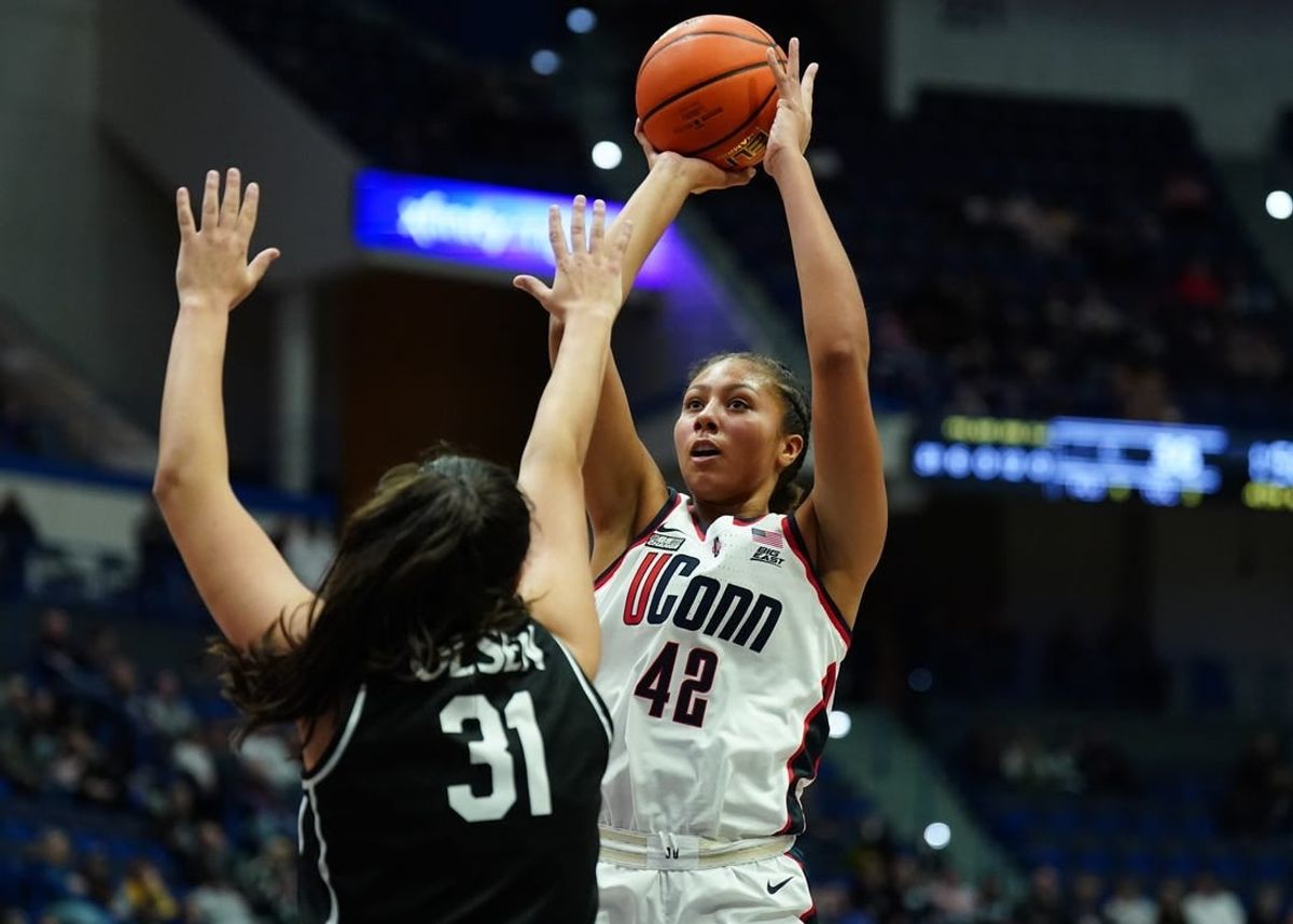 Jan 10, 2024; Hartford, Connecticut, USA; UConn Huskies forward Amari DeBerry (42) shoots against Providence Friars forward Olivia Olsen (31) in the second half at XL Center.
