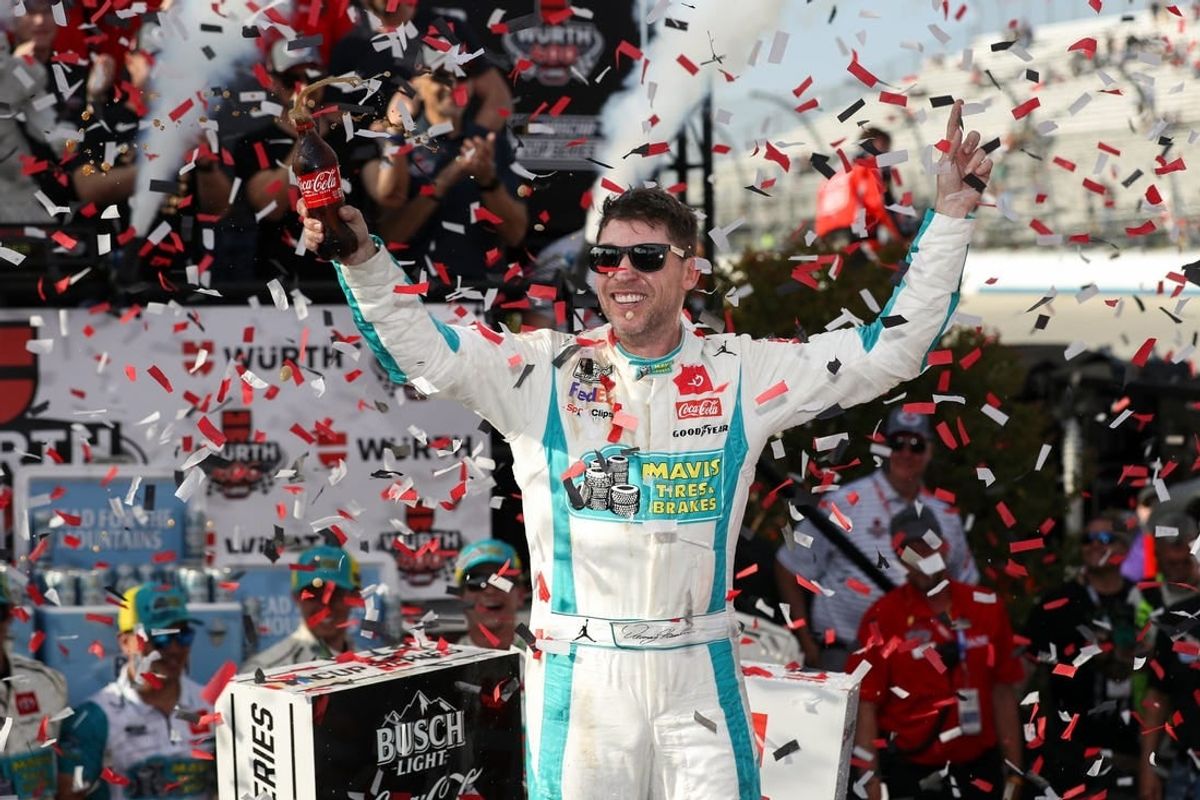 Apr 28, 2024; Dover, Delaware, USA; NASCAR Cup Series driver Denny Hamlin celebrates in victory lane after winning the Wurth 400 at Dover Motor Speedway.