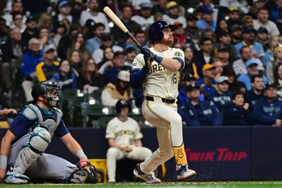 Apr 5, 2024; Milwaukee, Wisconsin, USA; Milwaukee Brewers designated hitter Oliver Dunn (15) hits a solo home run in the fourth inning as Seattle Mariners catcher Cal Raleigh (29) looks on at American Family Field.