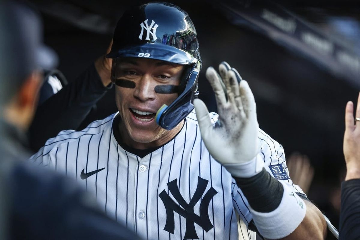 Apr 24, 2024; Bronx, New York, USA; New York Yankees center fielder Aaron Judge (99) celebrates in the dugout  after hitting a two run home run in the first inning against the Oakland Athletics at Yankee Stadium.
