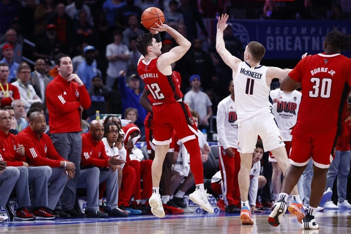 Mar 15, 2024; Washington, D.C., USA; North Carolina State Wolfpack guard Michael O'Connell (12) shoots a three point shot over Virginia Cavaliers guard Isaac McKneely (11) at the buzzer during the second half at Capital One Arena.
