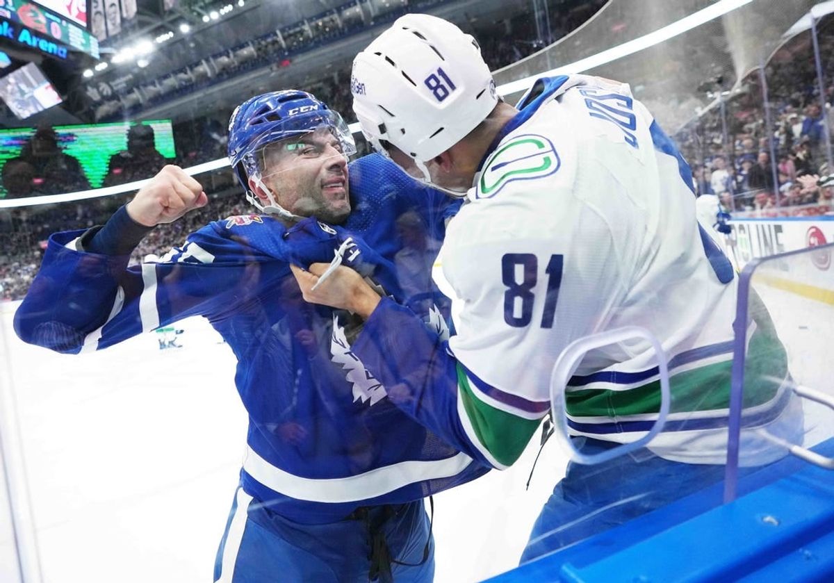 Nov 11, 2023; Toronto, Ontario, CAN; Toronto Maple Leafs defenseman Mark Giordano (55) fights with Vancouver Canucks center Dakota Joshua (81) during the first period at Scotiabank Arena.