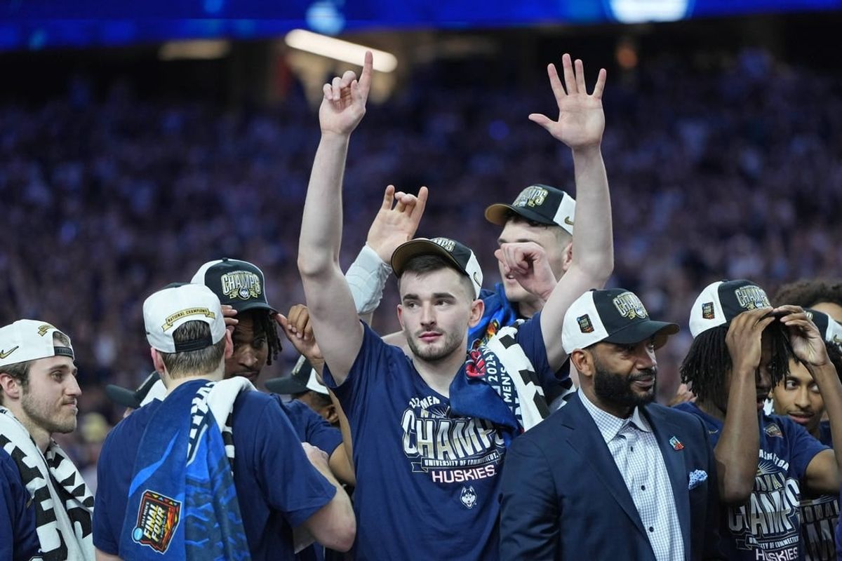Apr 8, 2024; Glendale, AZ, USA; Connecticut Huskies forward Alex Karaban (11) celebrates after winning the national championship game of the Final Four of the 2024 NCAA Tournament against the Purdue Boilermakers at State Farm Stadium.