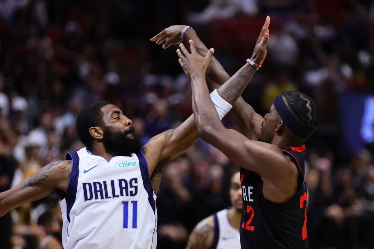 Apr 10, 2024; Miami, Florida, USA; Dallas Mavericks guard Kyrie Irving (11) defends against Miami Heat forward Jimmy Butler (22) during the fourth quarter at Kaseya Center.