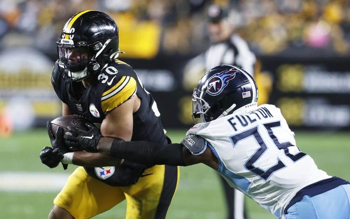 Nov 2, 2023; Pittsburgh, Pennsylvania, USA;  Pittsburgh Steelers running back Jaylen Warren (30) runs against Tennessee Titans cornerback Kristian Fulton (26) during the third quarter at Acrisure Stadium. Pittsburgh won 20-16.