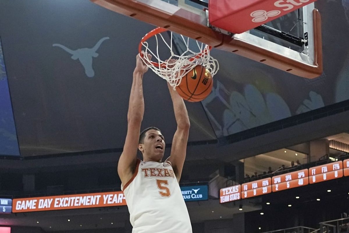 Jan 1, 2024; Austin, Texas, USA; Texas Longhorns forward Kadin Shedrick (5) dunks during the first half against the Texas-Arlington Mavericks at Moody Center.