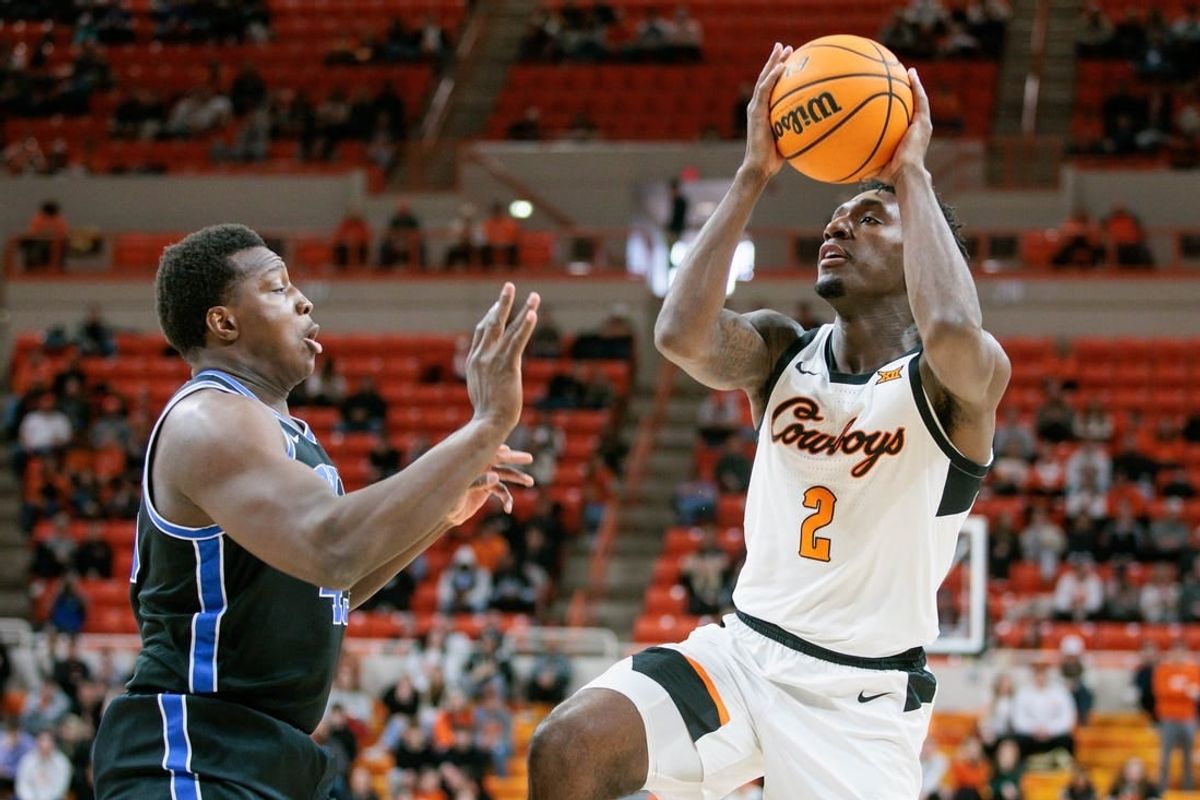 Feb 17, 2024; Stillwater, Oklahoma, USA; Oklahoma State Cowboys forward Eric Dailey Jr. (2) shoots the ball over Brigham Young Cougars forward Fousseyni Traore (45) during the first half at Gallagher-Iba Arena.