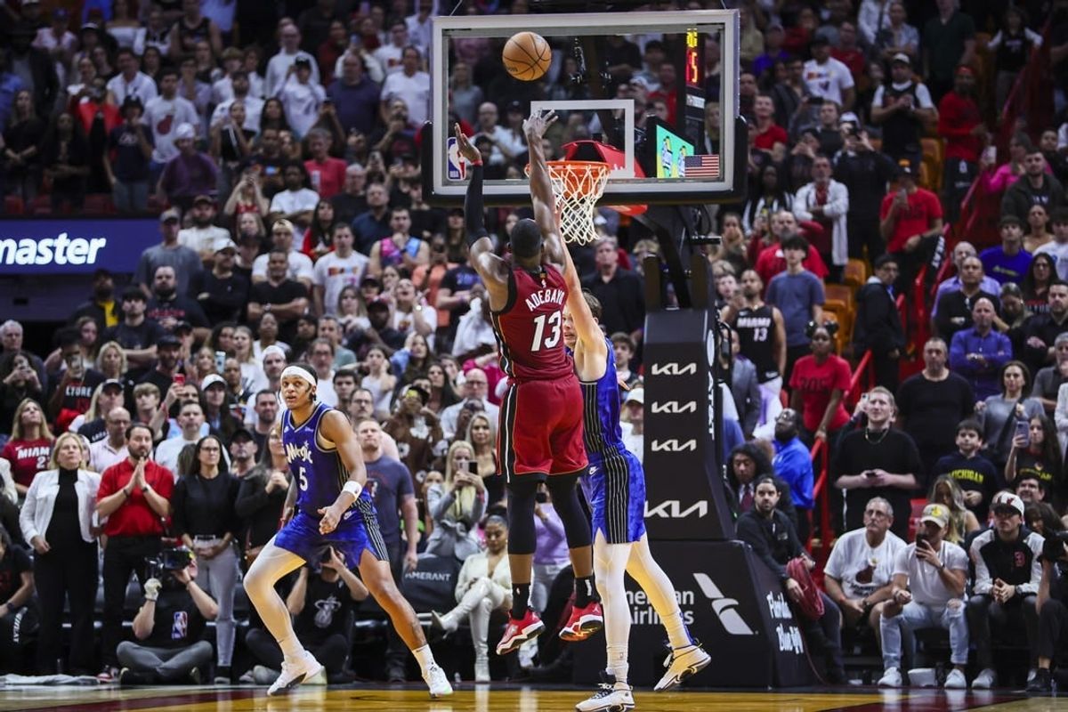 Jan 12, 2024; Miami, Florida, USA; Miami Heat center Bam Adebayo (13) scores against Orlando Magic center Moritz Wagner (21) during the fourth quarter at Kaseya Center.