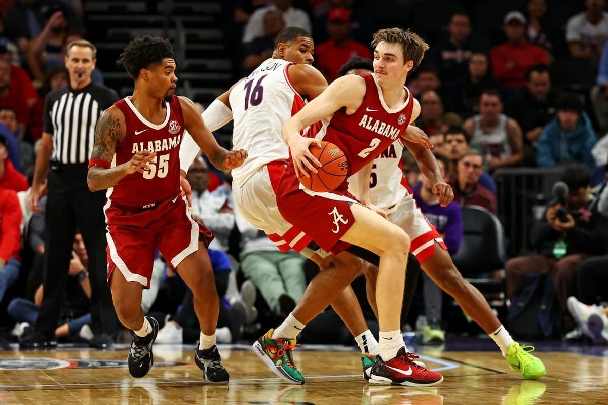 Dec 20, 2023; Phoenix, Arizona, USA; Alabama Crimson Tide forward Grant Nelson (2) handles the ball against Arizona Wildcats forward Keshad Johnson (16) during the second half in the Hall of Fame Series at Footprint Center.