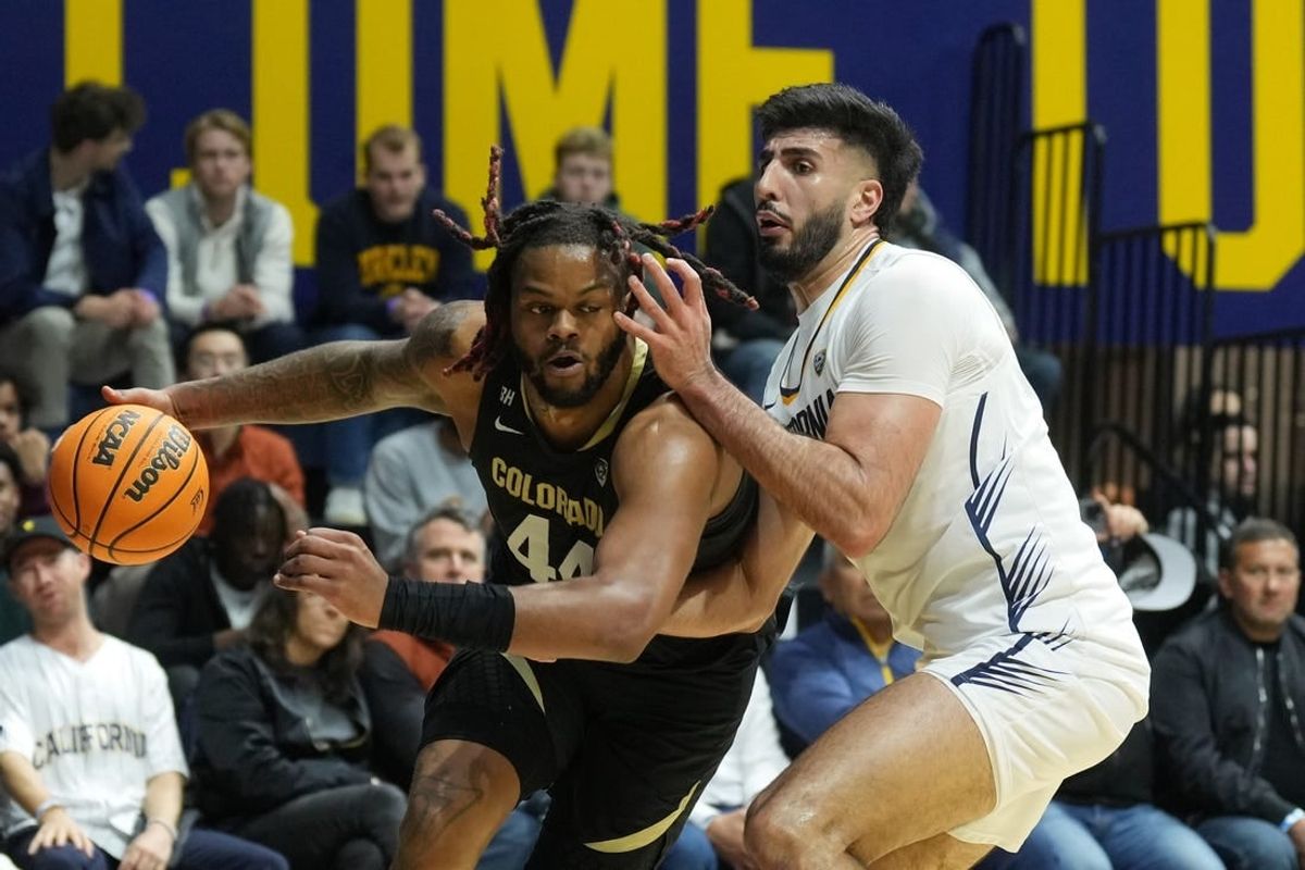 Jan 10, 2024; Berkeley, California, USA; Colorado Buffaloes center Eddie Lampkin Jr. (left) dribbles against California Golden Bears forward Fardaws Aimaq (right) during the first half at Haas Pavilion.