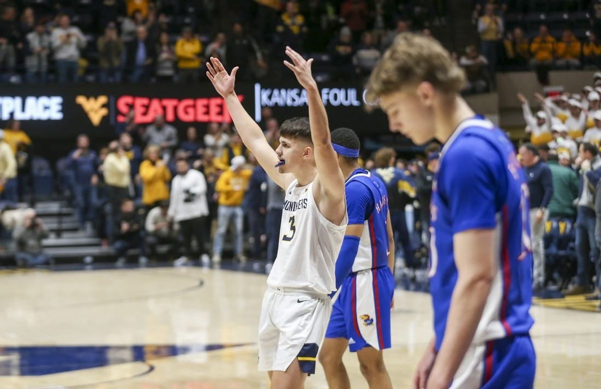Jan 20, 2024; Morgantown, West Virginia, USA; West Virginia Mountaineers guard Kerr Kriisa (3) celebrates late in the second half against the Kansas Jayhawks at WVU Coliseum.