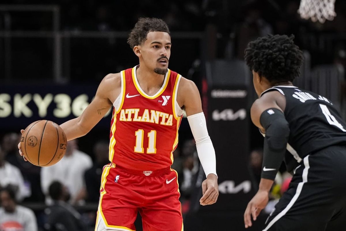 Dec 6, 2023; Atlanta, Georgia, USA; Atlanta Hawks guard Trae Young (11) controls the ball against Brooklyn Nets guard Dennis Smith Jr. (4) during the first half at State Farm Arena.
