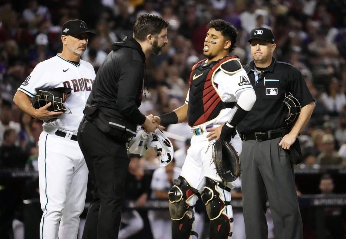 Oct 11, 2023; Phoenix, AZ, USA; Arizona Diamondbacks catcher Gabriel Moreno (14) reacts to an injury against the Los Angeles Dodgers in the fifth inning during Game 3 of the NLDS at Chase Field.