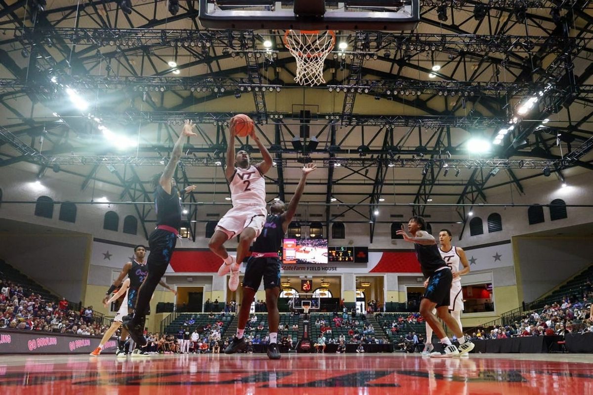 Nov 26, 2023; Kissimmee, FL, USA;  Virginia Tech Hokies guard MJ Collins (2) shoots the ball over Florida Atlantic Owls guard Johnell Davis (1) in the second half during the ESPN Events Invitational Championship game at State Farm Field House.