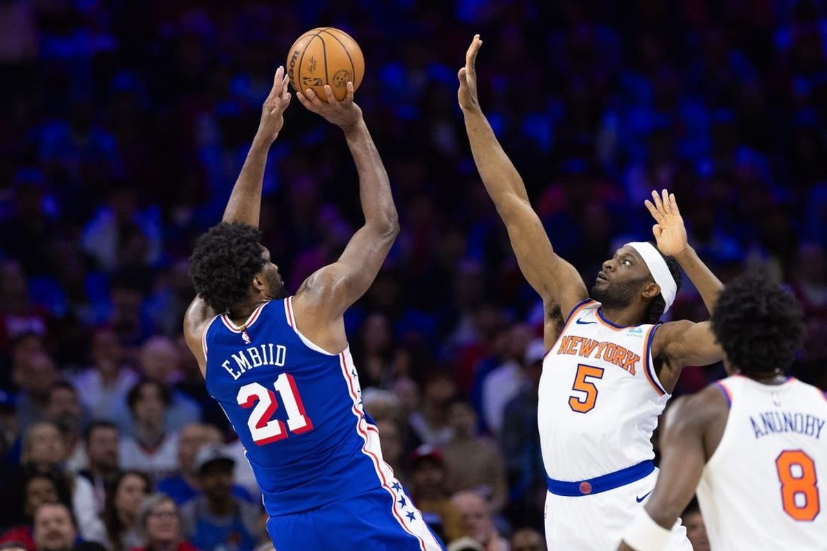 Apr 25, 2024; Philadelphia, Pennsylvania, USA; Philadelphia 76ers center Joel Embiid (21) shoots past New York Knicks forward Precious Achiuwa (5) during the first half of game three of the first round for the 2024 NBA playoffs at Wells Fargo Center.