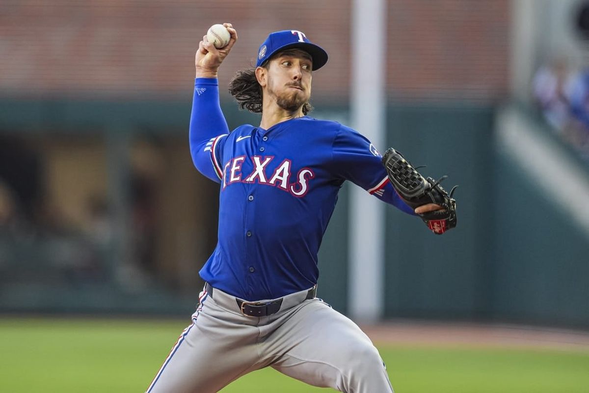 Apr 21, 2024; Cumberland, Georgia, USA; Texas Rangers starting pitcher Michael Lorenzen (23) pitches against the Atlanta Braves during the first inning at Truist Park.