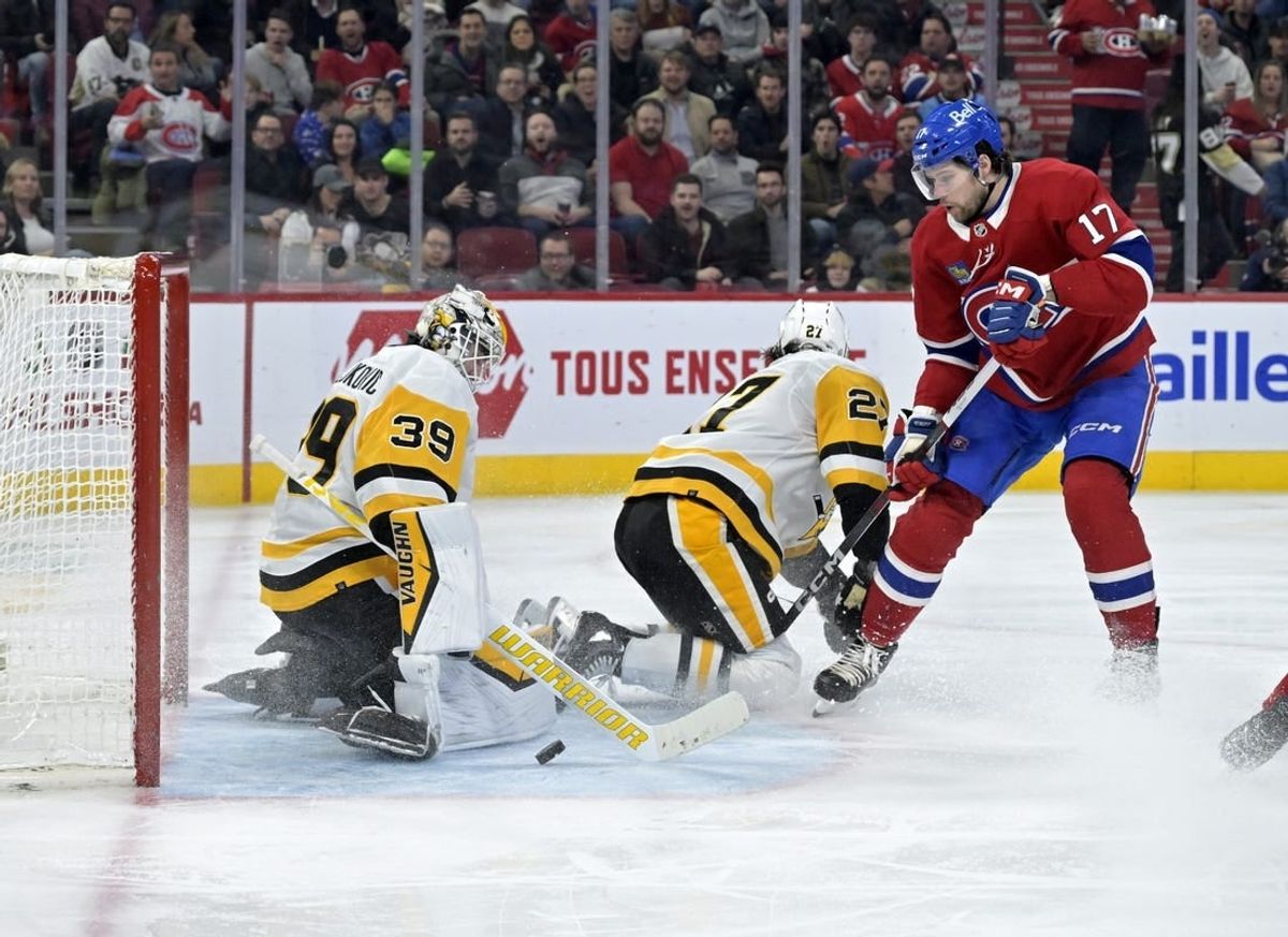 Dec 13, 2023; Montreal, Quebec, CAN; Pittsburgh Penguins Alex Nedeljkovic (39) stops Montreal Canadiens forward Josh Anderson (17) during the second period at the Bell Centre.