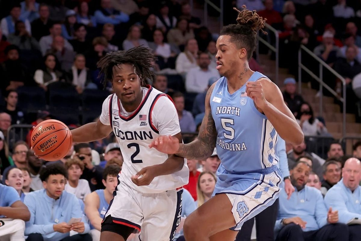 Dec 5, 2023; New York, New York, USA; Connecticut Huskies guard Tristen Newton (2) controls the ball against North Carolina Tar Heels forward Armando Bacot (5) during the first half at Madison Square Garden.
