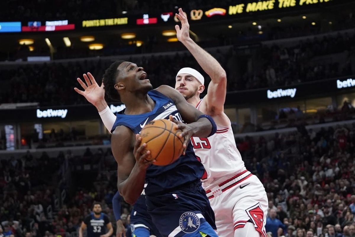 Feb 6, 2024; Chicago, Illinois, USA; Chicago Bulls guard Alex Caruso (6) defends Minnesota Timberwolves guard Anthony Edwards (5) during the second half at United Center.