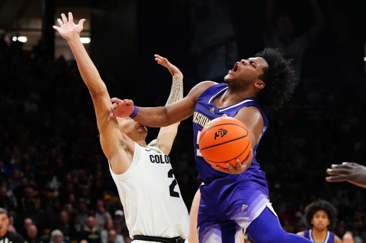 Dec 29, 2023; Boulder, Colorado, USA; Washington Huskies guard Sahvir Wheeler (5) shoots the ball at Colorado Buffaloes guard KJ Simpson (2) in the first half at the CU Events Center.