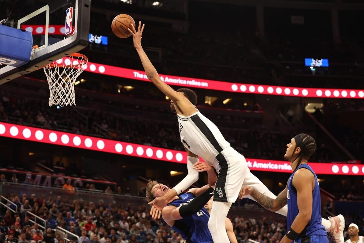 Feb 8, 2024; Orlando, Florida, USA;  Orlando Magic center Moritz Wagner (21) fouls San Antonio Spurs center Victor Wembanyama (1) during the second half at Kia Center.