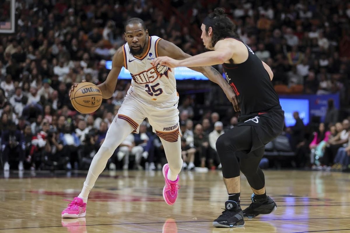 Jan 29, 2024; Miami, Florida, USA; Phoenix Suns forward Kevin Durant (35) moves to the basket against Miami Heat guard Jaime Jaquez Jr. (11) during the second quarter at Kaseya Center.