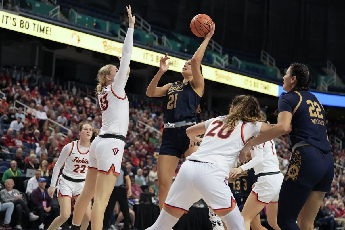 Mar 9, 2024; Greensboro, NC, USA; Notre Dame Fighting Irish forward Maddy Westbeld (21) shoots the ball over Notre Dame Fighting Irish guard Anna DeWolfe (13) during the second half at Greensboro Coliseum.