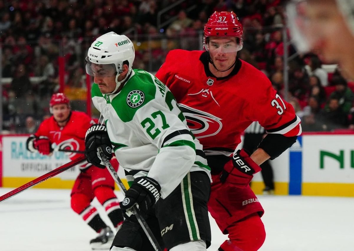 Feb 24, 2024; Raleigh, North Carolina, USA;  Dallas Stars left wing Mason Marchment (27) checks Carolina Hurricanes right wing Andrei Svechnikov (37) during the first period at PNC Arena.