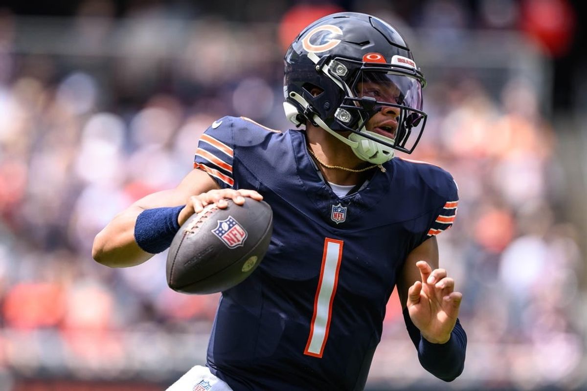 Aug 26, 2023; Chicago, Illinois, USA; Chicago Bears quarterback Justin Fields (1) scrambles against the Buffalo Bills during the first quarter at Soldier Field.