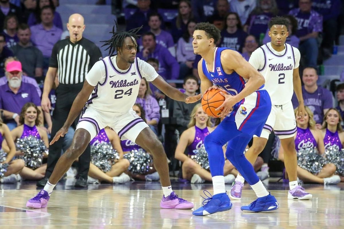 Feb 5, 2024; Manhattan, Kansas, USA; Kansas Jayhawks guard Kevin McCullar Jr. (15) is guarded by Kansas State Wildcats forward Arthur Maluma (24) during the first half at Bramlage Coliseum.