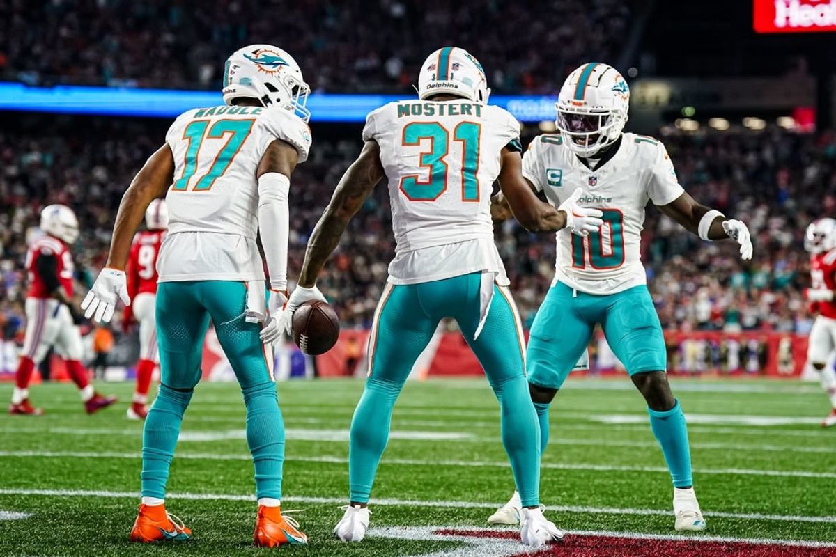 Sep 17, 2023; Foxborough, Massachusetts, USA; Miami Dolphins running back Raheem Mostert (31) celebrates with wide receiver Tyreek Hill (10) and wide receiver Jaylen Waddle (17) after scoring against the New England Patriots in the second quarter at Gillette Stadium.