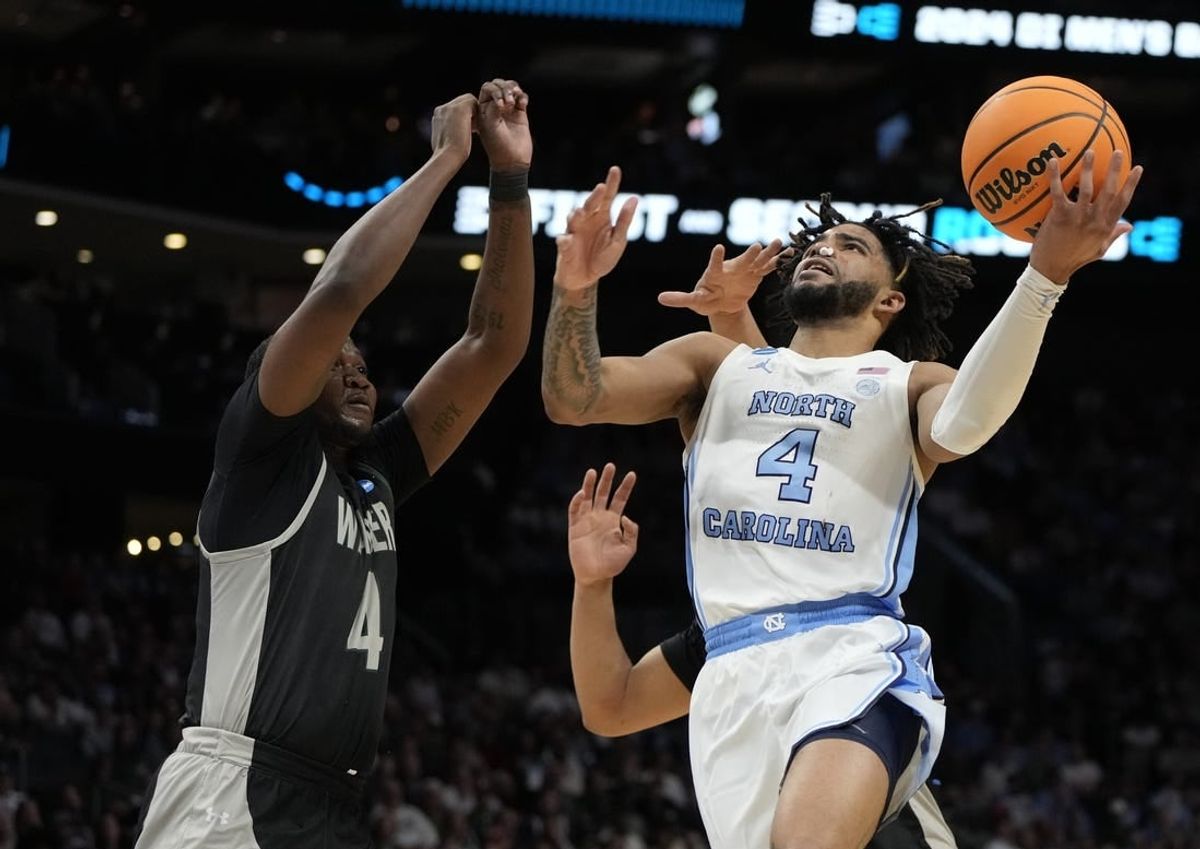 March 21, 2024, Charlotte, NC, USA; North Carolina Tar Heels guard RJ Davis (4) shoots against Wagner Seahawks forward Tyje Kelton (4) in the first round of the 2024 NCAA Tournament at the Spectrum Center.