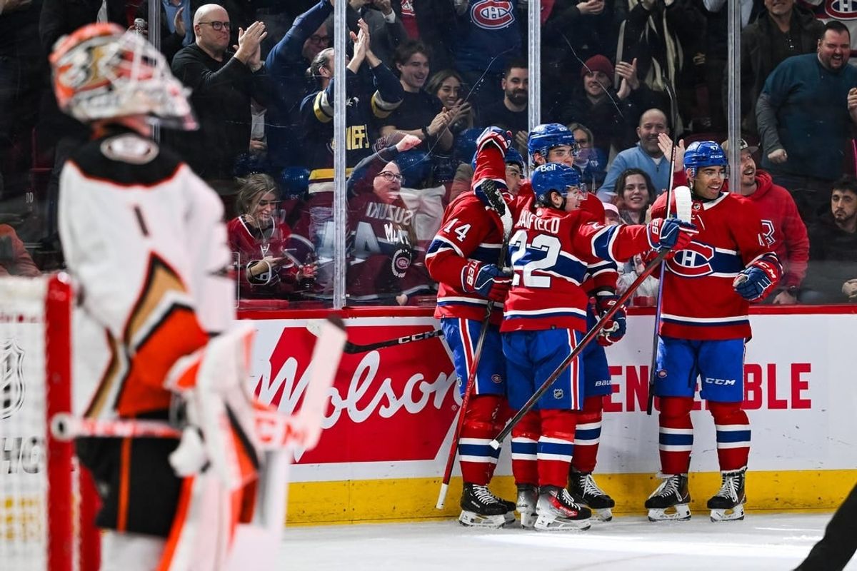 Feb 13, 2024; Montreal, Quebec, CAN; Montreal Canadiens center Nick Suzuki (14) celebrates his first goal of the game against the Anaheim Ducks with his teammates during the second period at Bell Centre.