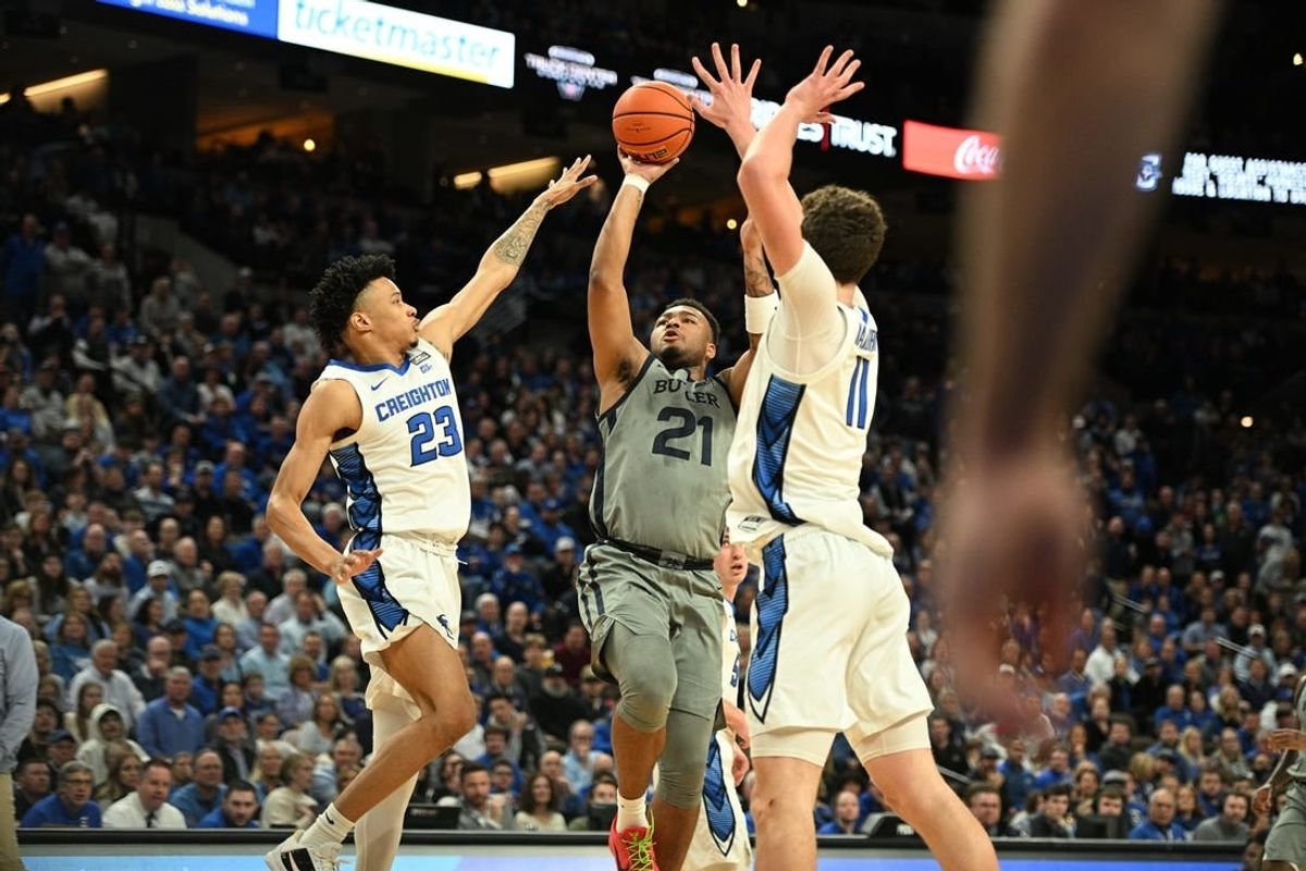 Feb 2, 2024; Omaha, Nebraska, USA; Butler Bulldogs guard Pierre Brooks (21) shoots over Creighton Bluejays guard Trey Alexander (23) and center Ryan Kalkbrenner (11) in the first half at CHI Health Center Omaha.
