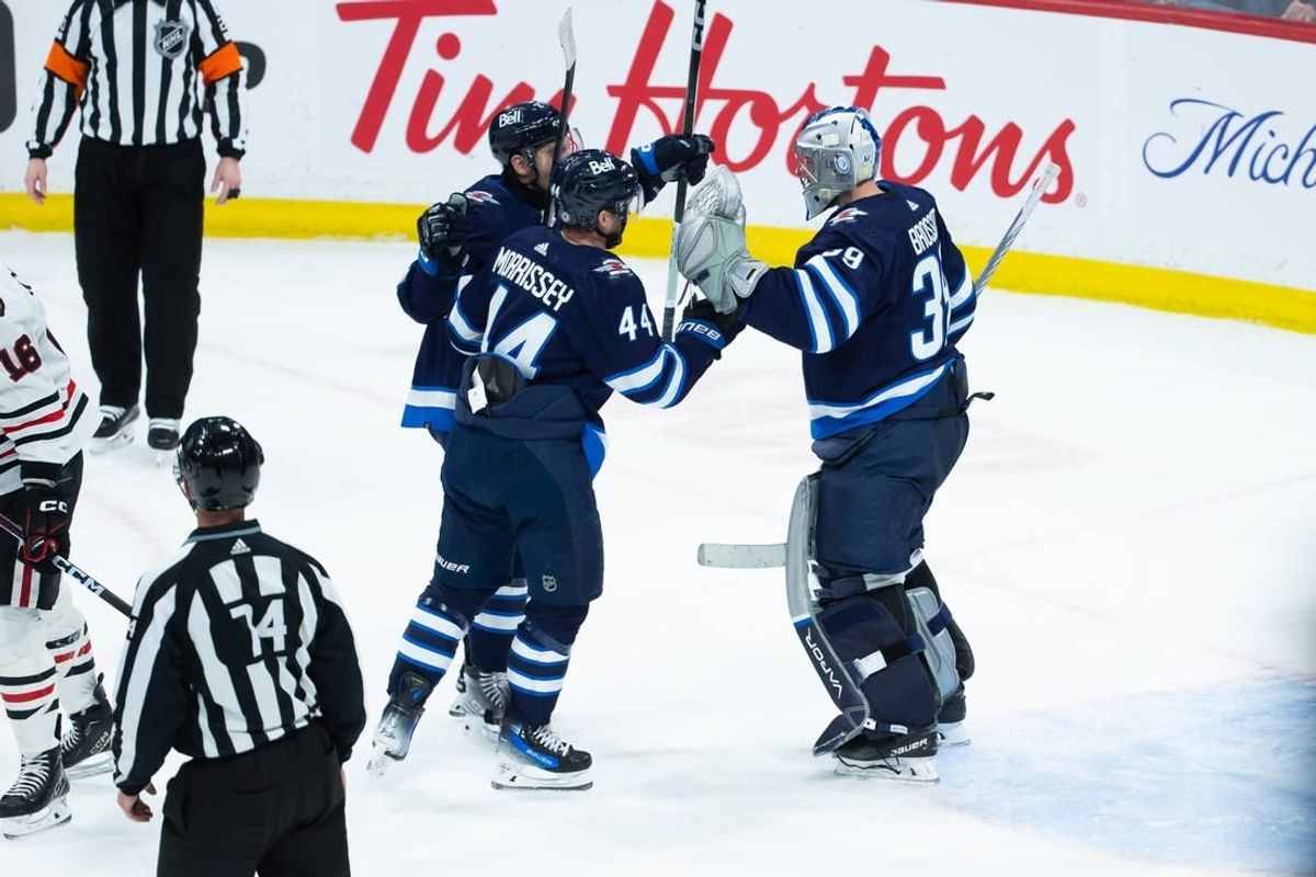 Jan 11, 2024; Winnipeg, Manitoba, CAN; Winnipeg Jets goalie Laurent Boissoit (39) is congratulated by his team mates on his win against the Chicago Blackhawks at the end of the third period at Canada Life Centre.
