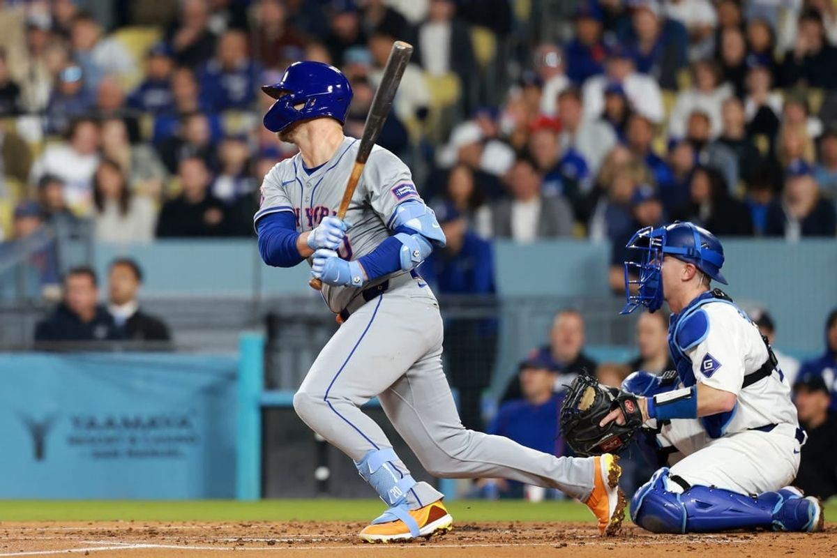 Apr 19, 2024; Los Angeles, California, USA;  New York Mets first base Pete Alonso (20) hits an RBI single during the third inning against the Los Angeles Dodgers at Dodger Stadium.