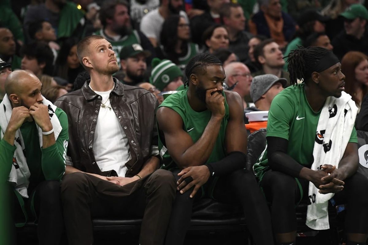 Jan 27, 2024; Boston, Massachusetts, USA;  Boston Celtics center Kristaps Porzingis (8) guard Jaylen Brown (7) and guard Jrue Holiday (4) on the bench during the second half against the LA Clippers at TD Garden.