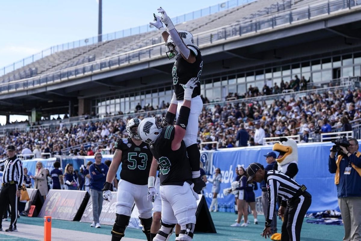 Dec 16, 2023; Conway, SC, USA; Ohio Bobcats running back Rickey Hunt (28) is lifted into the air by Ohio Bobcats offensive lineman Parker Titsworth (69) after a touchdown in the first half against the Georgia Southern Eagles at Brooks Stadium.