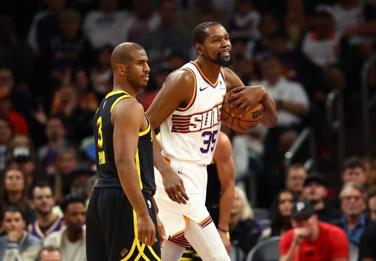Nov 22, 2023; Phoenix, Arizona, USA; Phoenix Suns forward Kevin Durant (35) alongside Golden State Warriors guard Chris Paul (3) in the first half at Footprint Center.