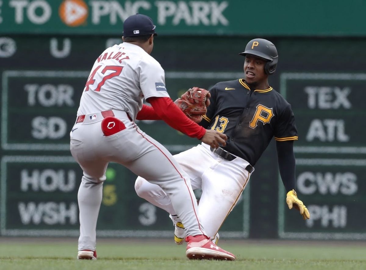 Apr 21, 2024; Pittsburgh, Pennsylvania, USA;  Boston Red Sox second baseman Enmanuel Valdez (47) tags Pittsburgh Pirates third baseman Ke'Bryan Hayes (13) out at second base after Hayes hit a single and attempted to advance after a Red Sox throwing error during the fourth inning at PNC Park.