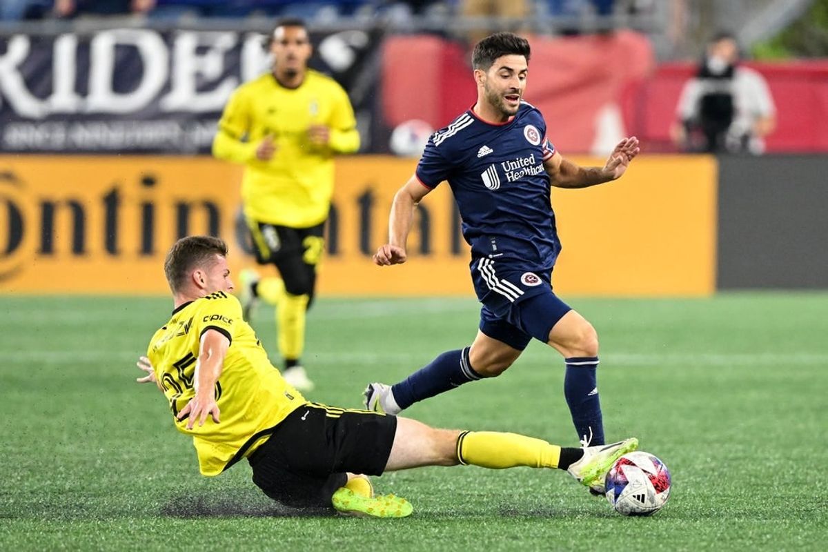 Oct 4, 2023; Foxborough, Massachusetts, USA; Columbus Crew midfielder Sean Zawadzki (25) defends New England Revolution midfielder Carles Gil (10) during the first half at Gillette Stadium.
