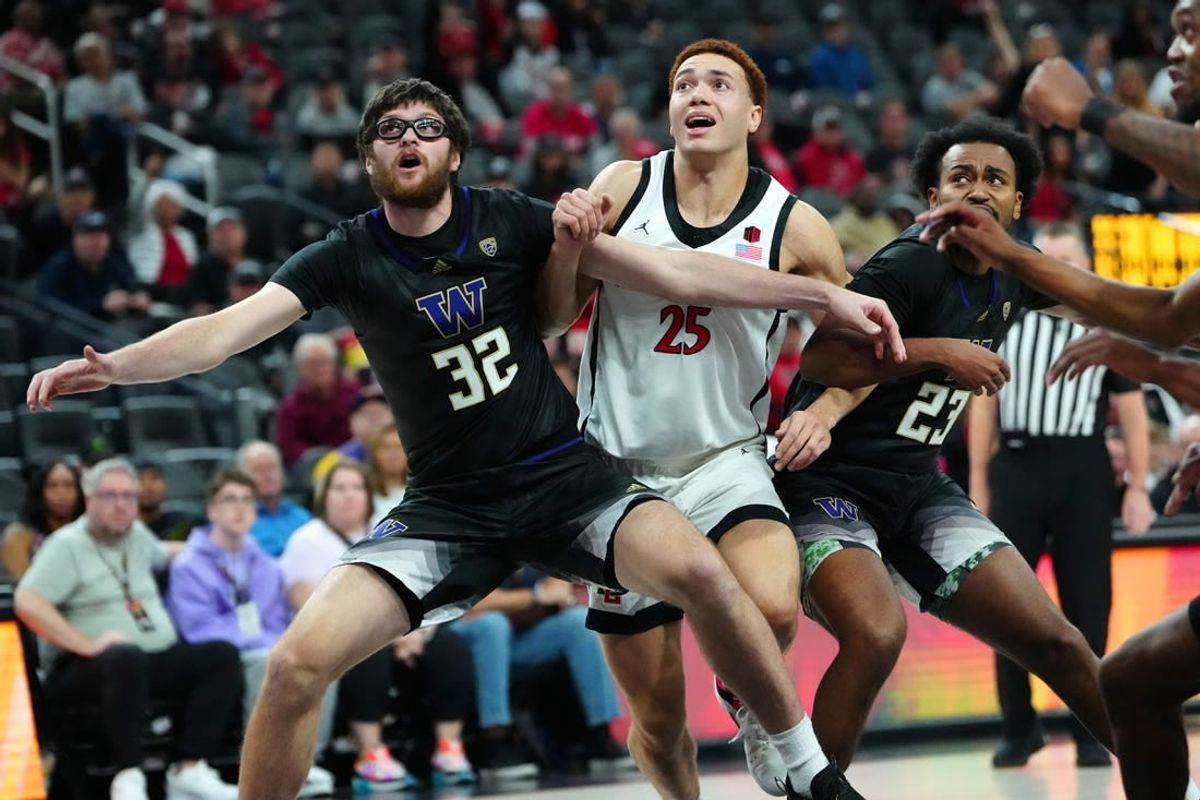 Nov 19, 2023; Las Vegas, NV, USA; San Diego State Aztecs forward Elijah Saunders (25) is blocked out by Washington Huskies forward Wilhelm Breidenbach (32) and guard Anthony Holland (23) during the first half at T-Mobile Arena.