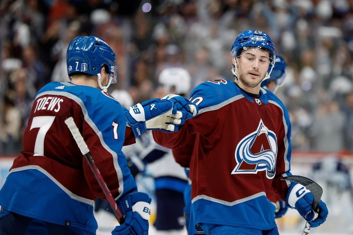 Apr 26, 2024; Denver, Colorado, USA; Colorado Avalanche center Ross Colton (20) celebrates his goal with defenseman Devon Toews (7) in the third period against the Winnipeg Jets in game three of the first round of the 2024 Stanley Cup Playoffs at Ball Arena.