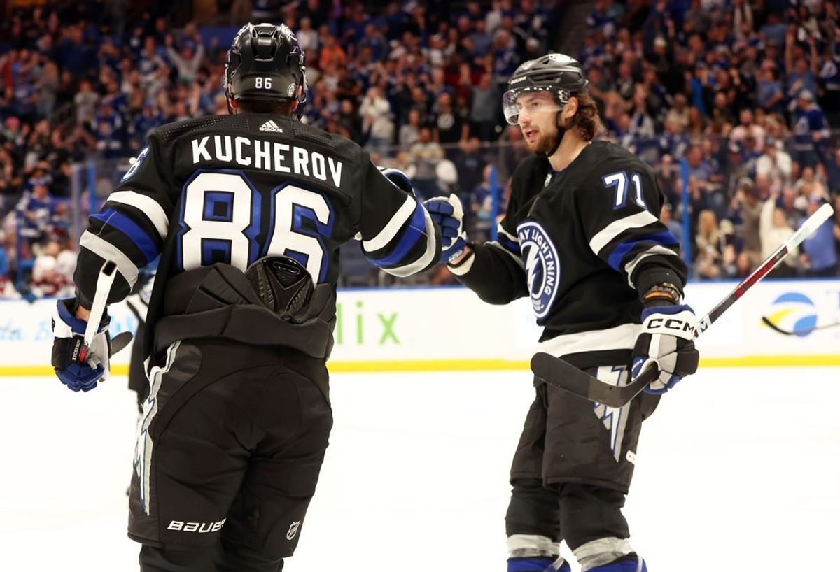 Feb 15, 2024; Tampa, Florida, USA; Tampa Bay Lightning right wing Nikita Kucherov (86) is Colorado Avalanche by Tampa Bay Lightning center Anthony Cirelli (71) after he scored a goal against the Colorado Avalanche during the first period at Amalie Arena.