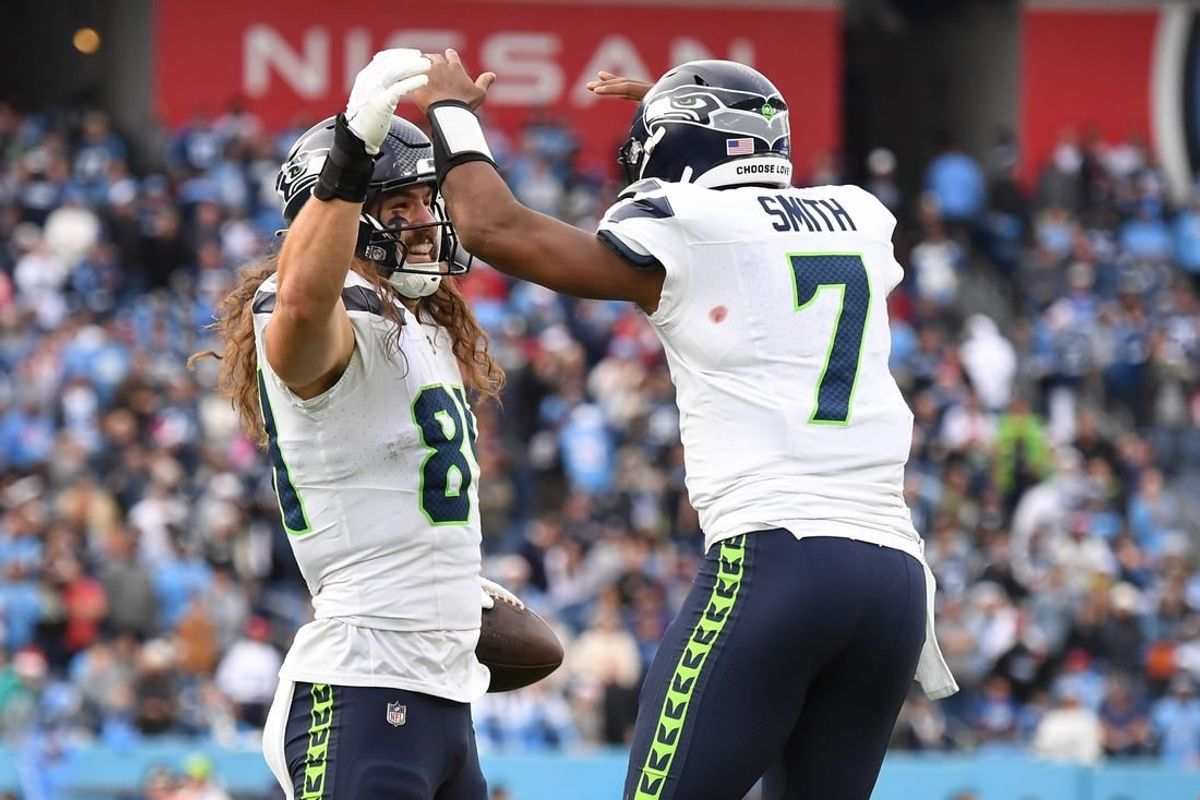 Dec 24, 2023; Nashville, Tennessee, USA; Seattle Seahawks tight end Colby Parkinson (84) celebrates with quarterback Geno Smith (7) after scoring the game-winning touchdown during the second half against the Tennessee Titans at Nissan Stadium.
