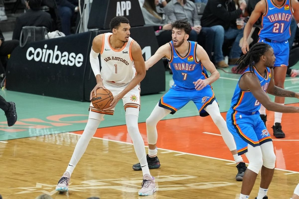 Jan 24, 2024; San Antonio, Texas, USA;  San Antonio Spurs center Victor Wembanyama (1) looks to pass in front of Oklahoma City Thunder forward Chet Holmgren (7) in the first half at Frost Bank Center.