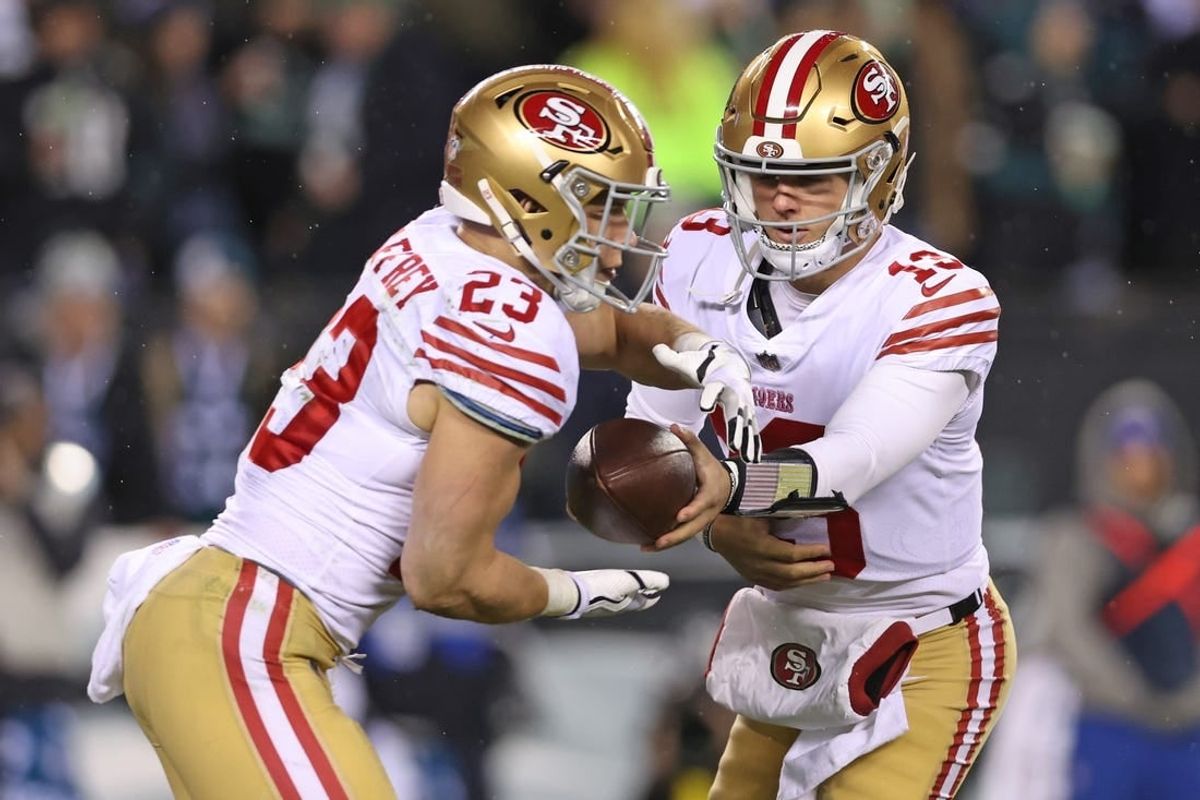 Jan 29, 2023; Philadelphia, Pennsylvania, USA; San Francisco 49ers quarterback Brock Purdy (13) hands off to running back Christian McCaffrey (23) against the Philadelphia Eagles during the fourth quarter in the NFC Championship game at Lincoln Financial Field.
