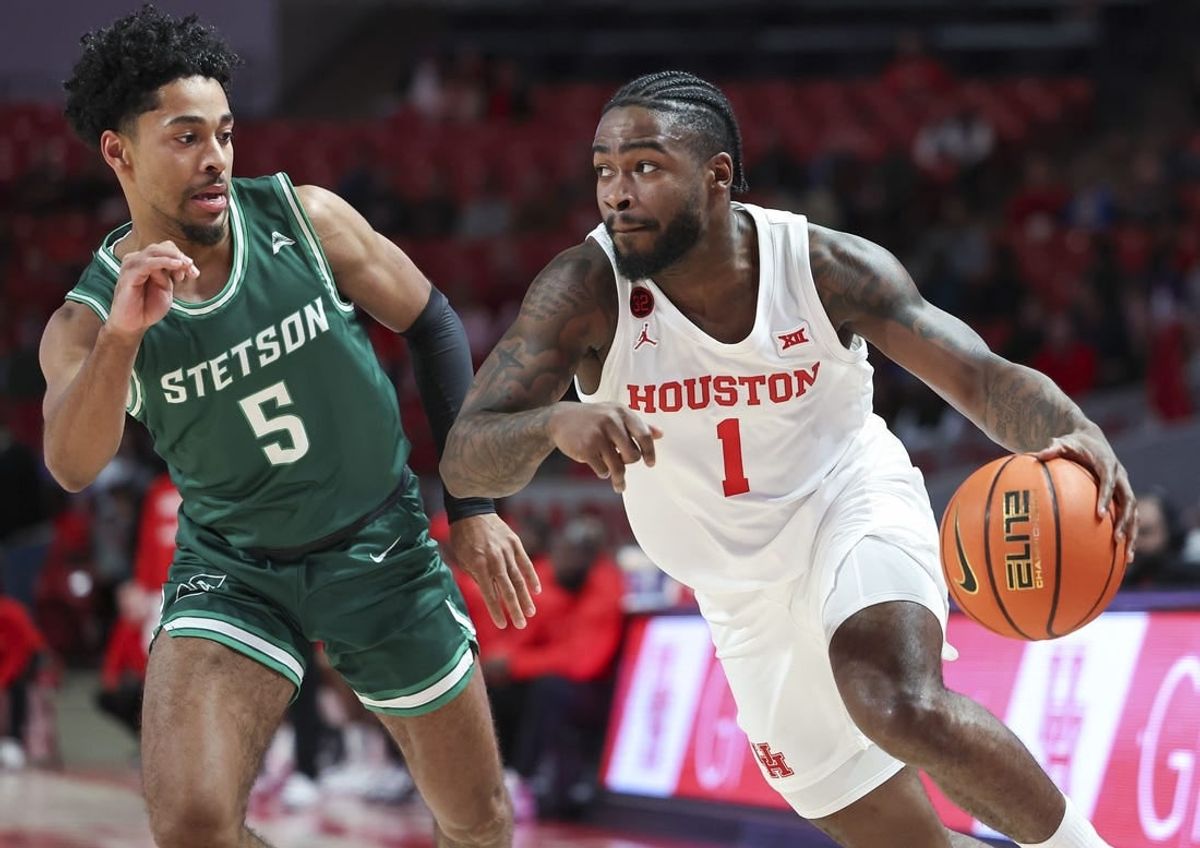 Nov 13, 2023; Houston, Texas, USA; Houston Cougars guard Jamal Shead (1) controls the ball as Stetson Hatters guard Jalen Blackmon (5) defends during the first half at Fertitta Center.