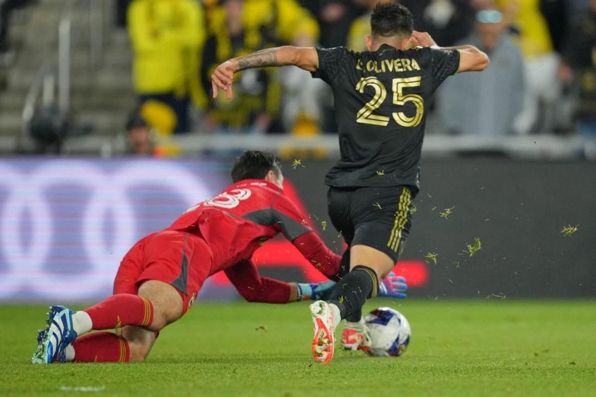 Dec 9, 2023; Columbus, OH, USA; Columbus Crew goalkeeper Patrick Schulte (28) makes a save against Los Angeles FC forward Cristian Olivera (25) during the second half in the 2023 MLS Cup championship game at Lower.com Field.